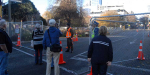 Christchurch Before and After the Earthquakes. A police officer and soldier from the New Zealand Army stand guard at one of the entrances to the closed central business district in Gloucester Street during June 2012