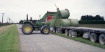 Unloading silage bails for wrapping on a dairy farm near Dunsandel. Minolta 7s Rangefinder Camera.
