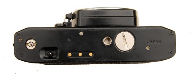 Ricoh XR-1s bottom plate. Ricoh XR-1s bottom plate. The bottom plate showing the contacts and mechanical coupling for a motor winder. I used a similar sort of motor winder on my old Pentax ME Super, of the same time period. The motor winder provides a good grip on the camera.