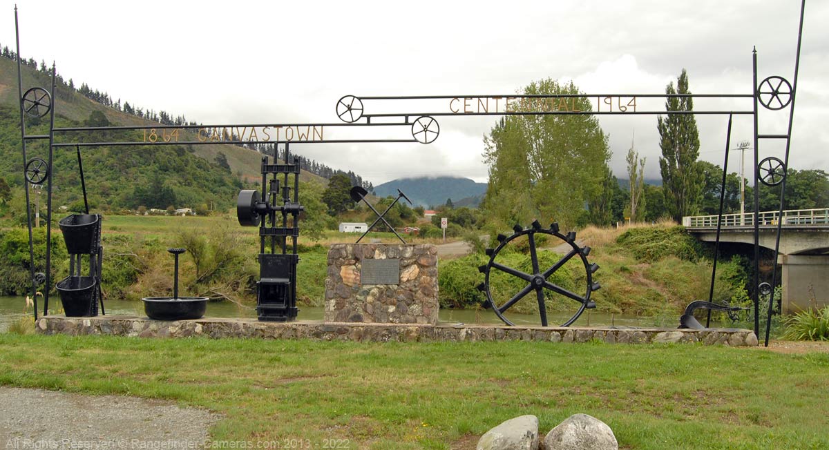 Photograph taken a decade later of the Centennial Memorial unveiled in 1964 to Mark 100 years since gold was first discovered In the Wakamarina Valley. Photograph taken at Canvastown.