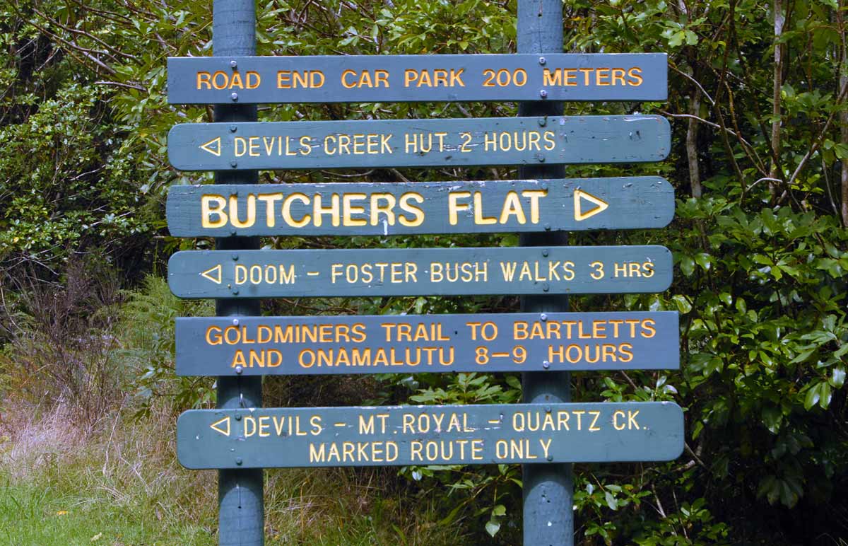 This signpost is about 200m from Butchers Flat. If you are very energetic you can tramp up over the hills to Onamalutu in the Wairau Valley. There are also mountain bike trails in the Wakamarina Valley. Butchers Flat is approx. 15km by mostly gravel road from Canvastown. As an added exciting bonus various small creeks run across the road meaning it is probably best avoided following heavy rain.